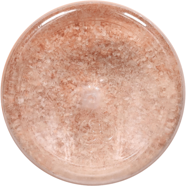 Close-up image of a round container filled with pink Himalayan salt, showcasing its coarse texture and natural hues. Ideal for culinary use, spa treatments, or decorative purposes.