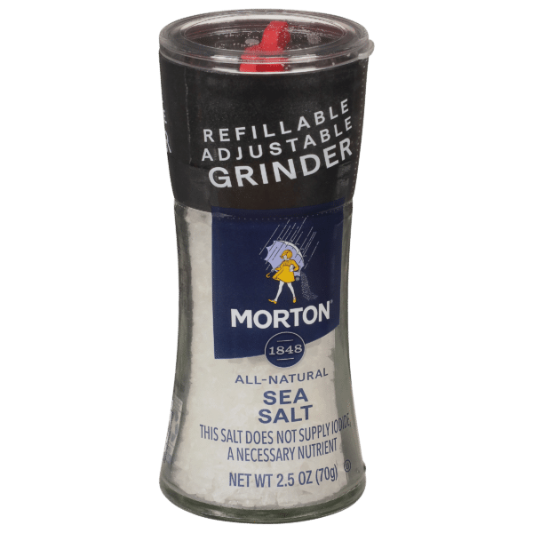 Morton all-natural sea salt in a refillable adjustable grinder, 2.5 oz (70g), featuring a clear glass body and a black lid with a red dispensing mechanism. Ideal for seasoning and enhancing flavors in cooking.