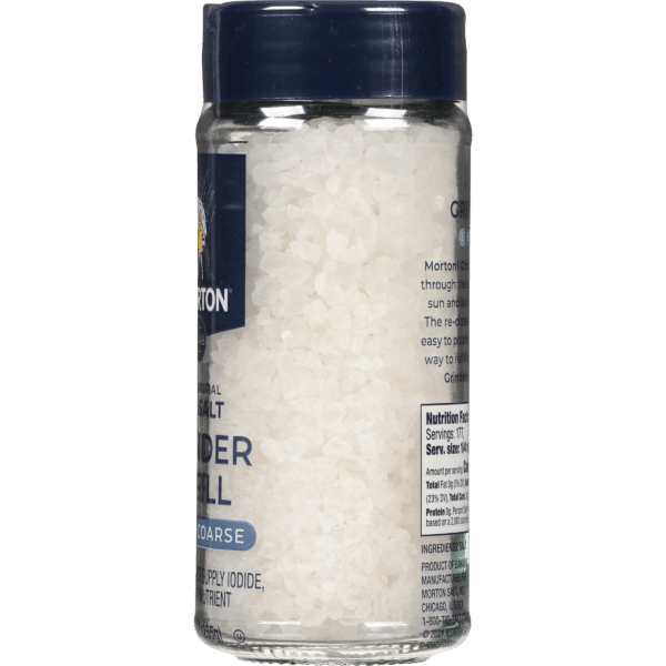 Coarse sea salt in a clear glass jar with a blue lid, featuring the Morton brand logo and nutritional information on the label. Ideal for cooking and seasoning, this natural salt enhances flavor and is a source of essential minerals.