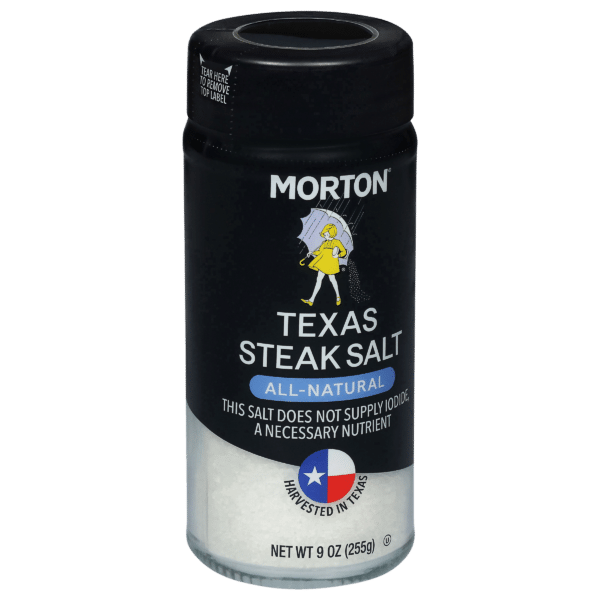 Morton Texas Steak Salt container, featuring an all-natural seasoning blend, 9 oz size, labeled with a Texas symbol and a note about iodine content. Ideal for enhancing the flavor of steaks and other meats.