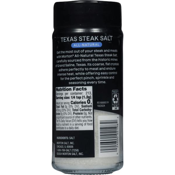 Morton All-Natural Texas Steak Salt shaker featuring a black label with product information, nutrition facts, and ingredients. The shaker contains coarse, flat crystals ideal for seasoning steak and meats, sourced from Grand Saline, Texas.