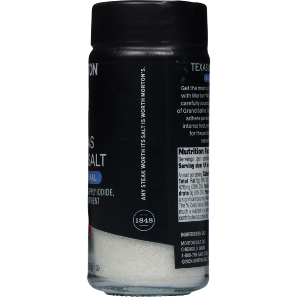 Morton Texas Style Sea Salt container featuring a black label, nutrition facts, and ingredient list. Ideal for enhancing the flavor of meats and dishes, this sea salt is sourced from Grand Saline and emphasizes its natural qualities.