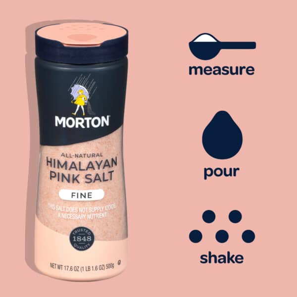 Morton Himalayan Pink Salt bottle with a fine grain, featuring instructions to measure, pour, and shake. The label emphasizes its all-natural quality and notes that it does not supply iodide, a necessary nutrient.