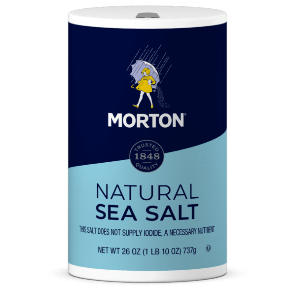 Morton Natural Sea Salt container, 26 oz, featuring a blue and dark blue design with a vintage logo and a warning about lack of iodide, ideal for seasoning and cooking.