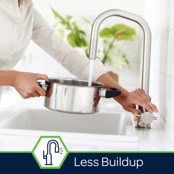 Person filling a stainless steel pot with water from a modern kitchen faucet, demonstrating efficient water flow with minimal buildup.