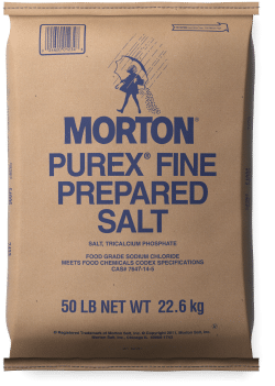 Brown paper bag of Morton Purex Fine Prepared Salt, weighing 50 pounds (22.6 kg), featuring blue text and an illustration of a woman pouring salt. The bag indicates it contains food-grade sodium chloride and meets food chemical code specifications.