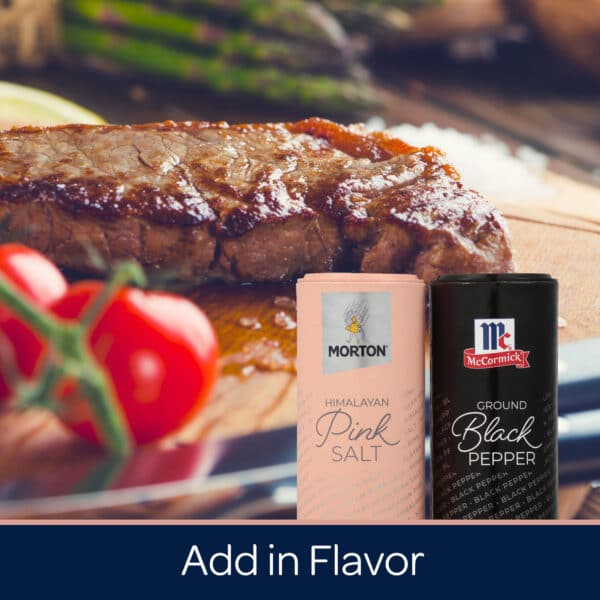 Juicy grilled steak garnished with fresh tomatoes and asparagus, accompanied by Morton Himalayan Pink Salt and McCormick Ground Black Pepper, showcasing essential seasonings for enhancing flavor in cooking.