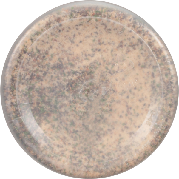 Close-up view of a clear container filled with a textured blend of spices or seasoning, showcasing a mixture of light brown, green, and dark flecks, ideal for culinary use.