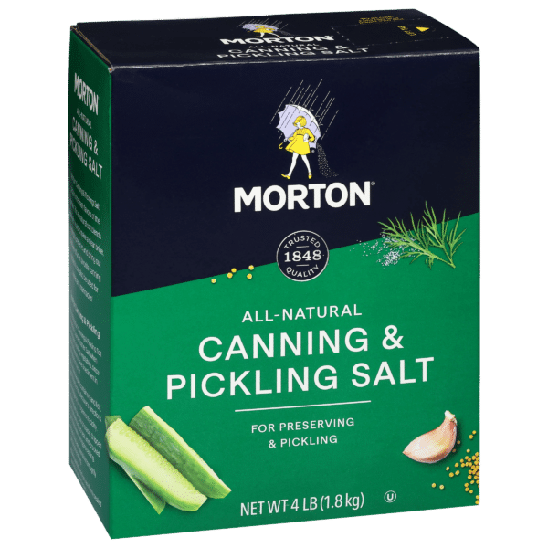 Morton all-natural canning and pickling salt box, 4 lb (1.8 kg), ideal for preserving and pickling vegetables like cucumbers, featuring a green and blue design with garlic and herbs illustrations.