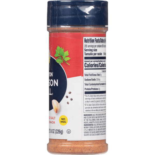 Container of seasoning salt with nutrition facts label, featuring ingredients such as salt, garlic, and onion. The packaging indicates a total of 205 servings, with no MSG. The prominent brand logo and a sprig of cilantro are visible on the front.