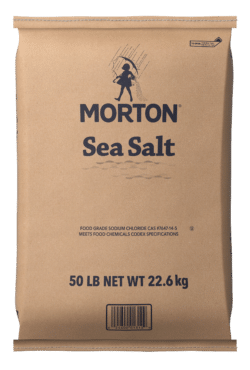 Brown paper bag of Morton Sea Salt, labeled with product information, weighing 50 pounds (22.6 kg), suitable for culinary use and meeting food safety standards.