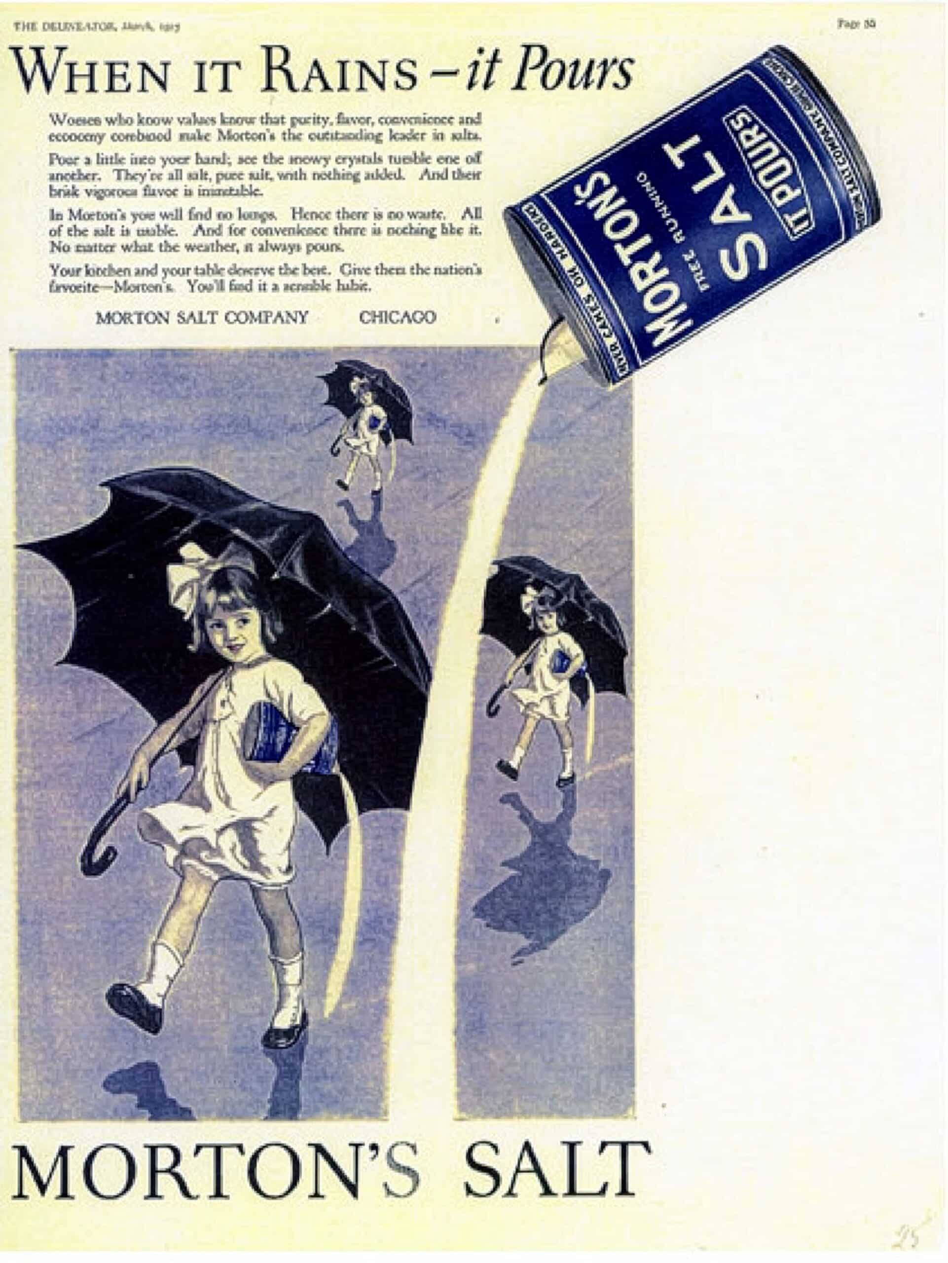 Vintage advertisement for Morton’s Salt featuring children with umbrellas walking in the rain, highlighting the brand's slogan "When it Rains - it Pours." The ad emphasizes the purity and quality of Morton’s Salt, showcasing the product's versatility and reliability in various weather conditions.