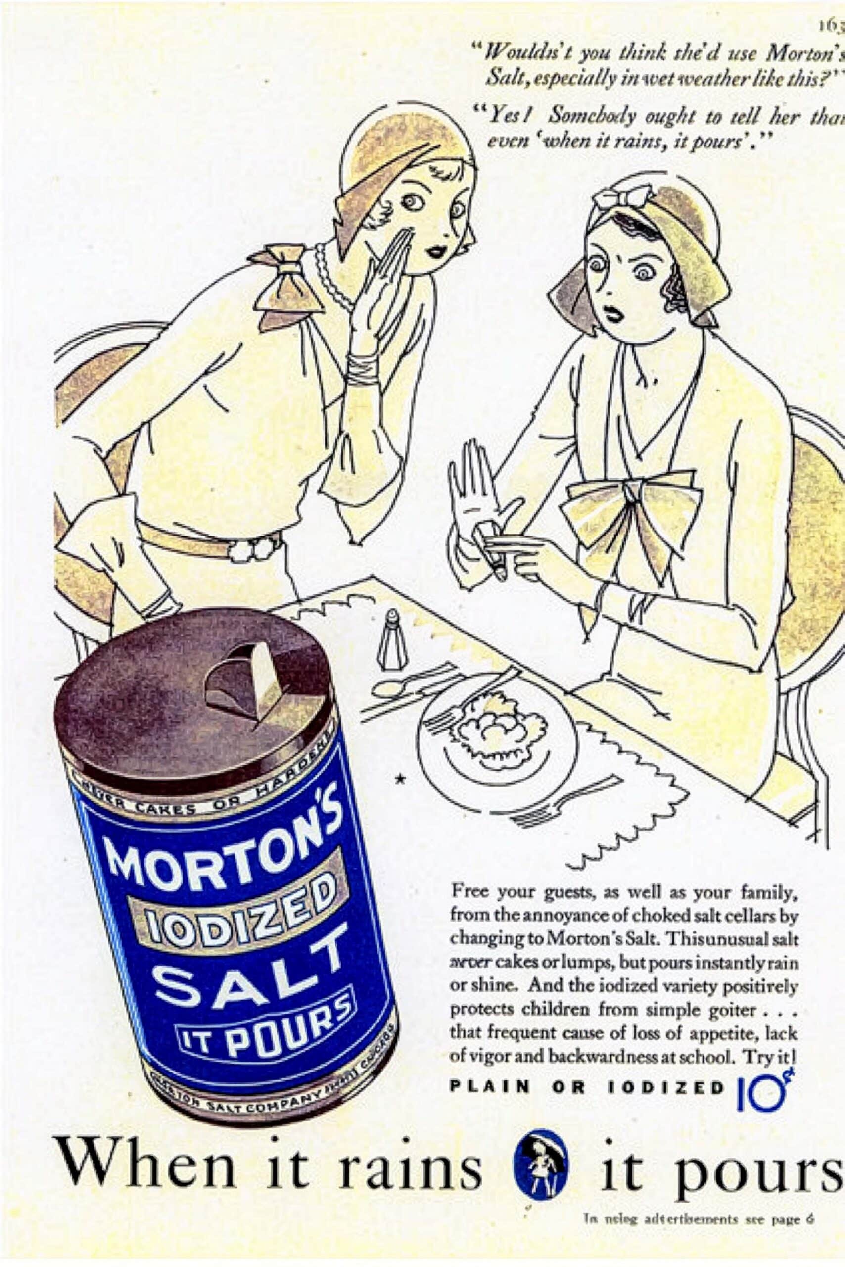 Vintage advertisement for Morton's Iodized Salt featuring two elegantly dressed women discussing the product, with a focus on its benefits of preventing clumping and its health advantages for children. The can prominently displays the Morton's branding, emphasizing the slogan "It Pours."