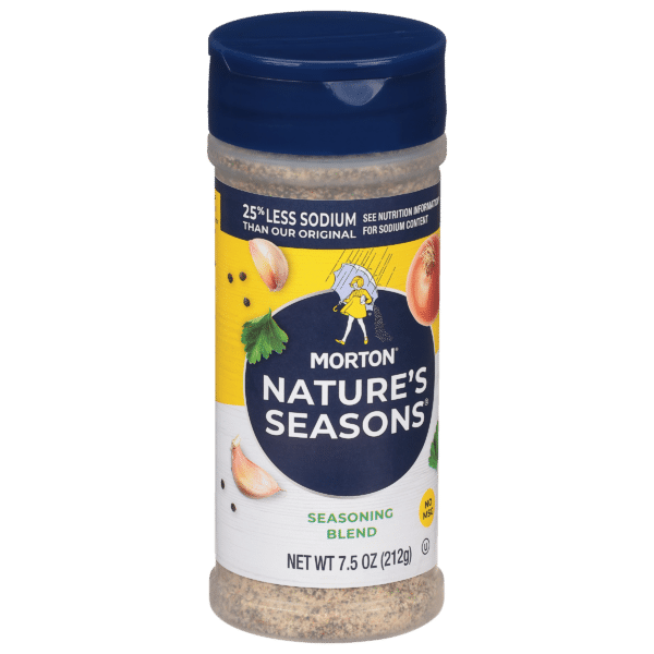 Morton Nature's Seasons seasoning blend in a 7.5 oz shaker, featuring a label that highlights 25% less sodium than the original recipe, with illustrations of onions and herbs. Ideal for enhancing the flavor of various dishes.
