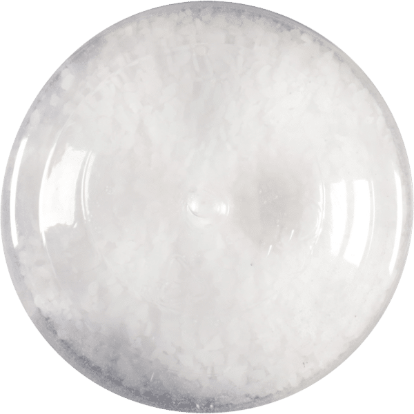Close-up of a transparent container filled with coarse white salt, showcasing its crystalline texture and round shape, ideal for culinary uses and seasoning.