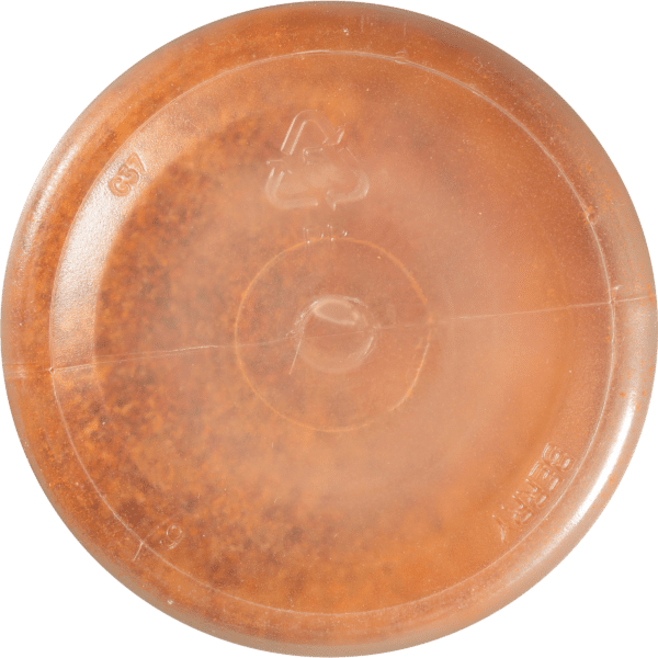 Close-up view of the bottom of a round, transparent, amber-colored container showcasing recycling symbols and product information, ideal for packaging and storage purposes.
