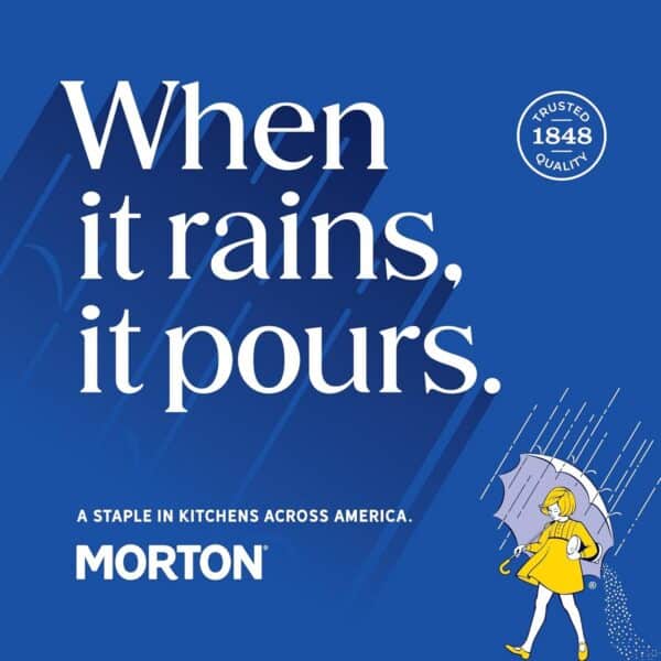 Morton salt advertisement featuring the phrase "When it rains, it pours" on a blue background, highlighting the brand's long-standing presence in American kitchens since 1848. The image includes a graphic of a girl with an umbrella, emphasizing the product's reliability and quality.