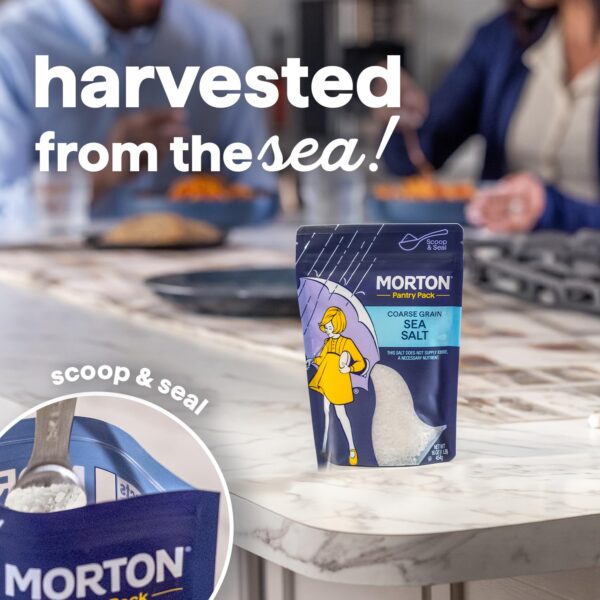 Morton Coarse Grain Sea Salt in a pantry pack on a kitchen countertop, featuring a spoon scooping salt from the resealable pouch, with people dining in the background. Ideal for enhancing flavor in various dishes.