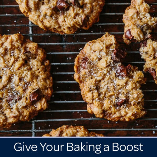 Freshly baked oatmeal chocolate chip cookies cooling on a wire rack, topped with a sprinkle of sea salt, showcasing a delicious homemade treat perfect for enhancing your baking skills.