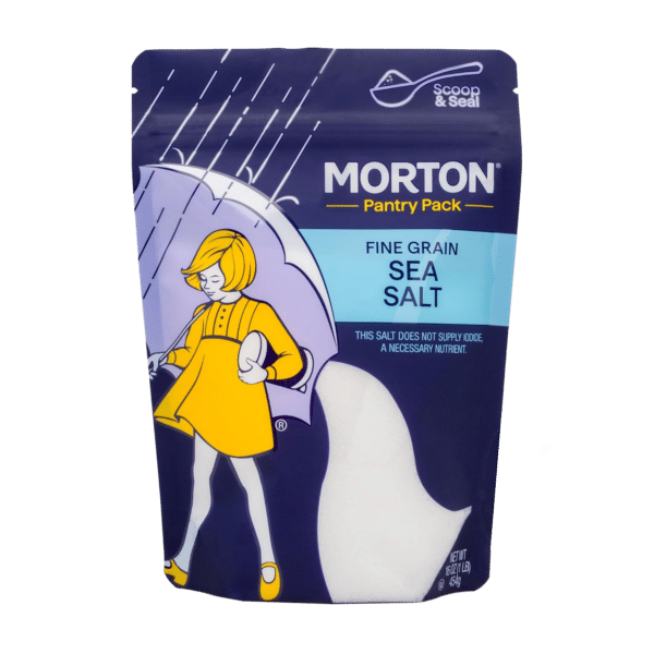 Morton Fine Grain Sea Salt Pantry Pack featuring a whimsical illustration of a girl with an umbrella, designed for easy scooping and sealing. Ideal for enhancing flavors in cooking and baking, this salt does not supply iodine, a necessary nutrient.