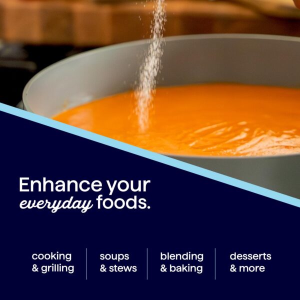 A close-up of a pot with vibrant orange soup as seasoning is being sprinkled in, highlighting cooking techniques for enhancing everyday foods like soups, stews, and desserts.