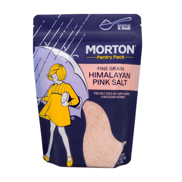 Morton Fine Grain Himalayan Pink Salt pantry pack featuring a colorful design with a girl holding an umbrella. The packaging highlights the salt's natural origins and notes that it does not supply iodine, an essential nutrient. Ideal for enhancing flavor in cooking and seasoning.